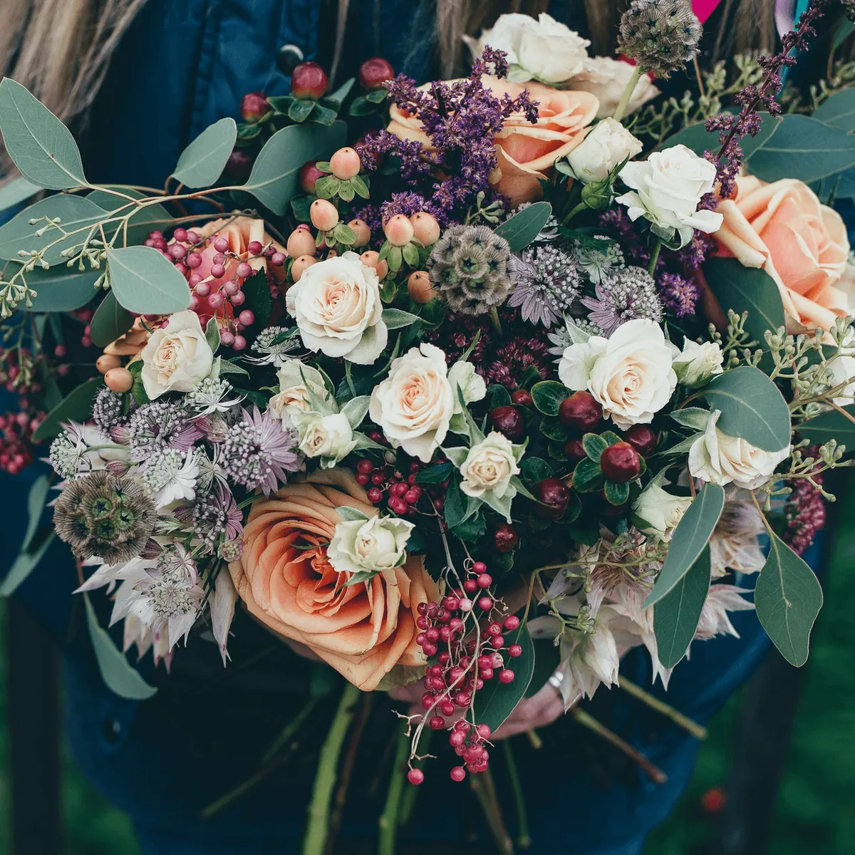A muted bouquet of cream and dusty pink roses